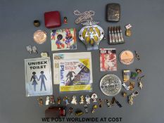 A quantity of collectables to include Golly badges, hallmarked silver cigarette case,