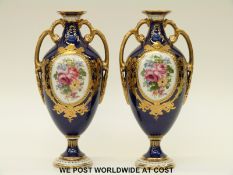 Royal Crown Derby pair of twin handled pedestal vases hand decorated with flower cartouches and