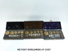 Three bakelite cased sets of metric weights