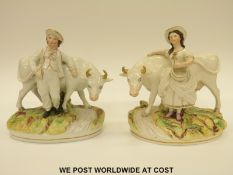 A pair of 19thC Staffordshire figures of a milkmaid and a boy with cows (22cm tall)
