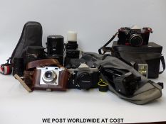 A quantity of cameras, lenses and accessories to include Praktica Super TL and TL5B,