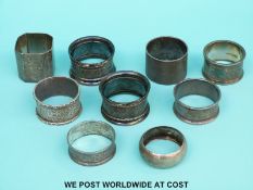 Eight various hallmarked silver napkin rings (192g) and a plated example