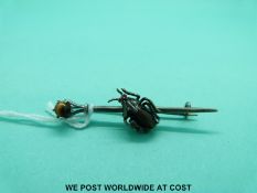 A silver brooch in the form of a beetle with a tigers eye cabochon as the body