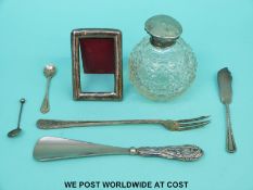 A silver topped cut glass perfume bottle, height 9cm, silver handled shoe horn,