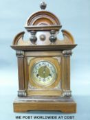 A mahogany and oak cased mantel clock with carved, fluted and turned decoration to the case,