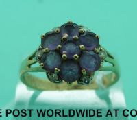 A 9ct gold ring set with amethysts in a flower cluster and diamonds to the edge (size W)