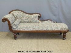 A Victorian rosewood chaise longue with scrolling armrest,