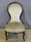 A 19th century upholstered balloon back nursing chair