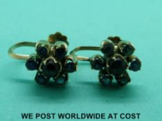 A pair of yellow metal earrings marked 18ct set with cat's eye sapphires surrounded by further