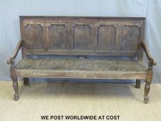 A Georgian oak settle with five panel back, plank seat,