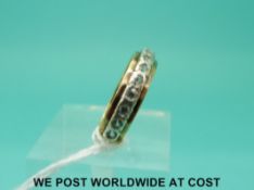A 9ct gold eternity ring set with clear stones (size M)