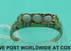 A 9ct gold ring set with three circular opal cabochons (size Q)