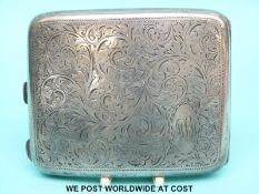 A hallmarked silver cigarette case with inscription to interior dated 1930 relating to the