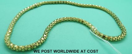 A yellow metal necklace marked 18ct made up of circular links forming a cylindrical necklace (30.