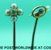 A yellow metal stick pin marked 15ct set with four pearls and an old cut diamond to the centre and