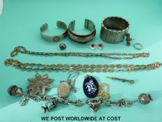 A silver ring set with marcasite, silver brooch, three white metal bangles,