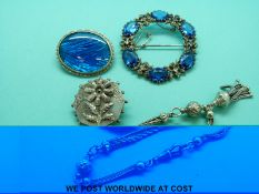 A white metal brooch set with butterfly wing, a white metal chatelaine,