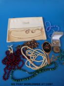 A collection of jewellery to include ivory and malachite beaded necklaces,