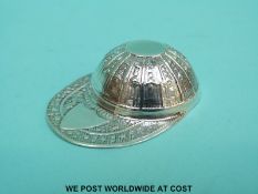 A white metal caddy spoon formed as a jockey's hat, marked sterling, length 5.