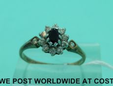 A 9ct gold ring set with a sapphire and paste (size P)