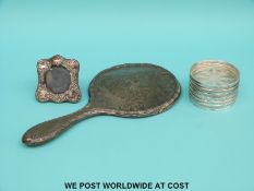 A set of six white metal mounted glass coasters marked sterling, diameter 8cm,