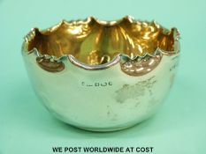A Victorian hallmarked silver sugar bowl with frilled edge and gilt wash interior,
