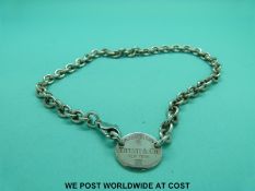 A silver necklace marked Tiffany & Co in box