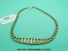 A yellow metal necklace made up of graduated rectangular links in the Cleopatra style (18g)