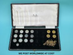 Thirteen white metal Scottish kilt buttons marked sterling and four shooting buttons in a Fraser,