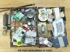 Two boxes of watch and clock repairing tools and spares to include watch glasses,