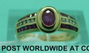 A 9ct gold ring set with rubies and diamonds (size L)