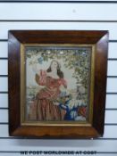 A 19th / 20th century framed tapestry of a lady picking grapes on a terrace with a boy holding a
