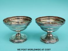 A pair of Georgian hallmarked silver pedestal salts with gilt wash interiors,