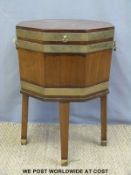 A 19thC hexagonal mahogany and brass bound wine cooler or cellarette raised on reeded legs and