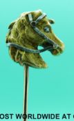A 19thC yellow metal stick pin in the form of a horse's head set with a diamond as the eye and two