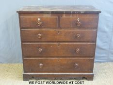 A Georgian oak chest of two over three drawers with turned handles and shaped frieze below (W110 x