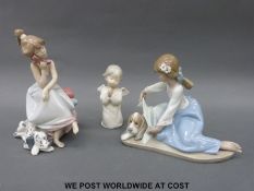 Three Lladro figures comprising girl with dog and blanket,