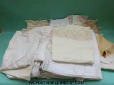A large quantity of white table cloths and runners to include a finely embroidered example and