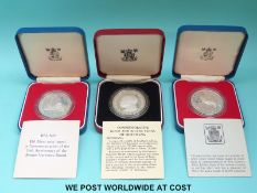 Three cased silver crown sized coins comprising Botswana,