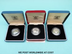 Three cased Royal Mint £1 silver coins 1983, 1985, 1986,