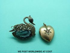 A heart shaped 9ct gold mourning pendant set with seed pearls and a ruby and a brooch in the form