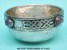 An Arts and Crafts George V hallmarked silver bowl with amethyst cabochon stones and hammered