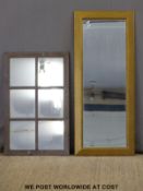 A gold framed mirror and another in the form of a window,