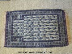 A rug with geometric repeating design and a throw with banded geometric design