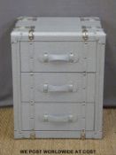 A chest of three drawers modelled as a vintage metal bound steamer trunk
