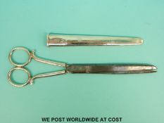 A large pair of scissors in hallmarked silver sheath,