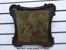 A 19th / 20th century framed tapestry of a young woman with a goat,