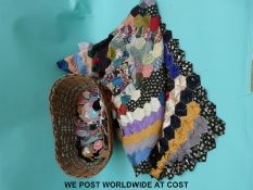 A basket containing a part finished patchwork quilt made up from hexagon shaped pieces in various