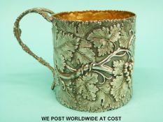 A William IV hallmarked silver tankard with continuous fruiting vine decoration and gilt wash