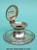 An Edward VII hallmarked silver capstan inkwell with notch for pen to lid,